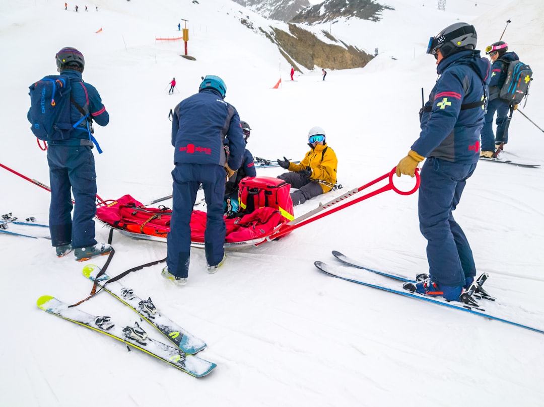 A man is picked up by ski mountain rescue.